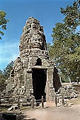 Ta Prohm temple - the temple west entrance, a well preserved gopura in the Bayon style with a tower with four faces of Lokesvara